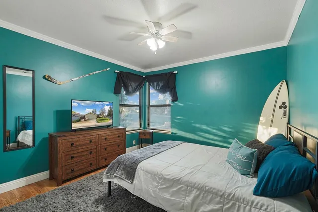 a bedroom with a bed and a television