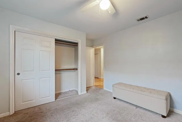 a hallway with closet and a couch