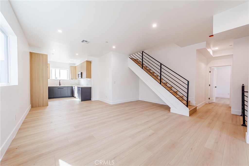 5209 20th Street, Unit A Los Angeles, CA 90016 - Photo 14 of 30 a view of a hallway with wooden floor and staircase