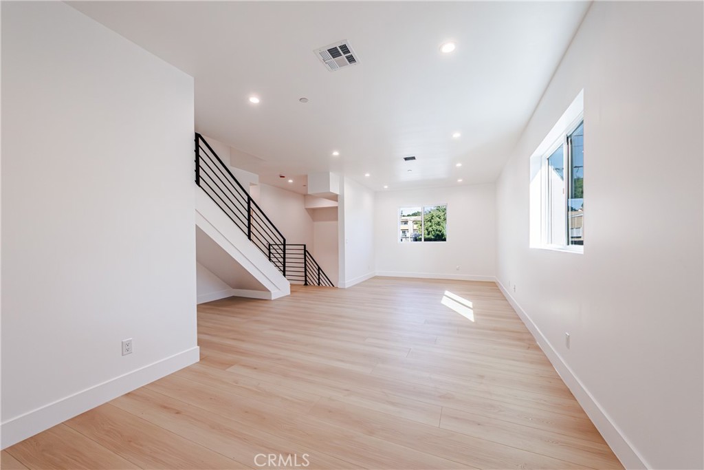 5209 20th Street, Unit A Los Angeles, CA 90016 - Photo 18 of 30 an empty room with wooden floor and windows