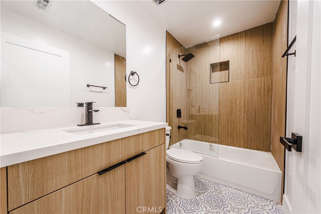 5209 20th Street, Unit A Los Angeles, CA 90016 - Photo 19 of 30 a bathroom with a sink a toilet a mirror and shower