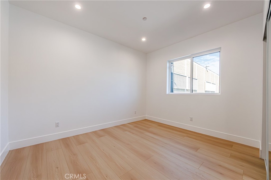 5209 20th Street, Unit A Los Angeles, CA 90016 - Photo 20 of 30 an empty room with wooden floor and windows