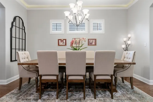 a view of a dining room with furniture and chandelier