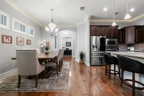 a kitchen with stainless steel appliances granite countertop a sink stove and cabinets