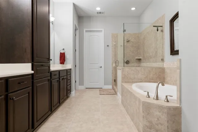a bathroom with a bathtub and a shower