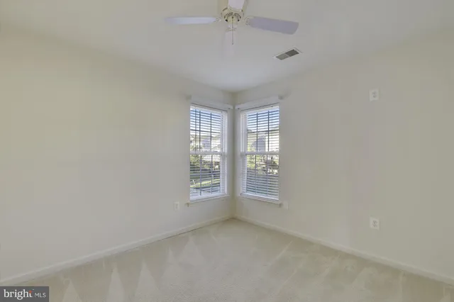 an empty room with a empty space and windows