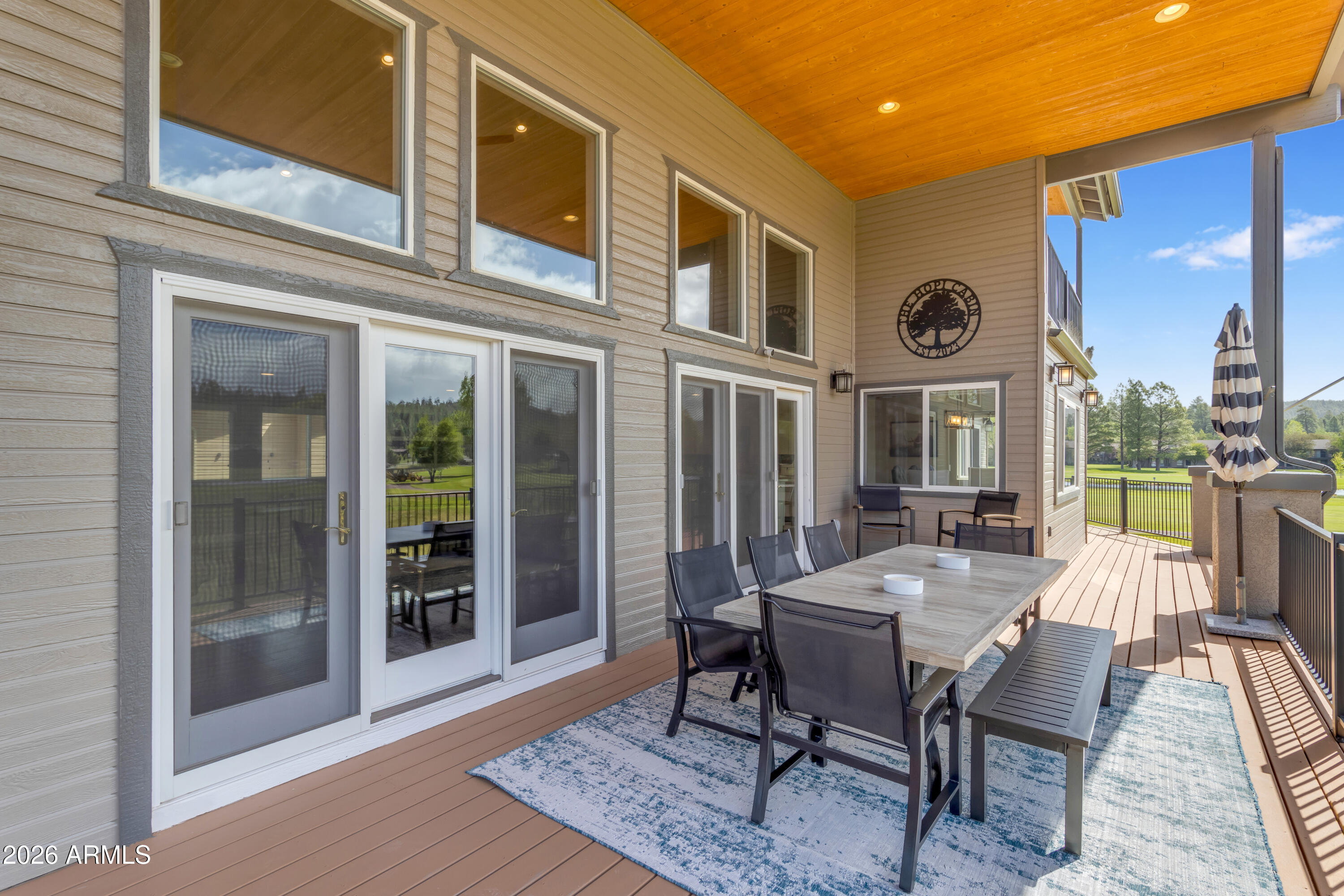 17975 Hopi Road Munds Park, AZ 86017 - Photo 6 of 58 a view of a patio with table and chairs with wooden floor and fence