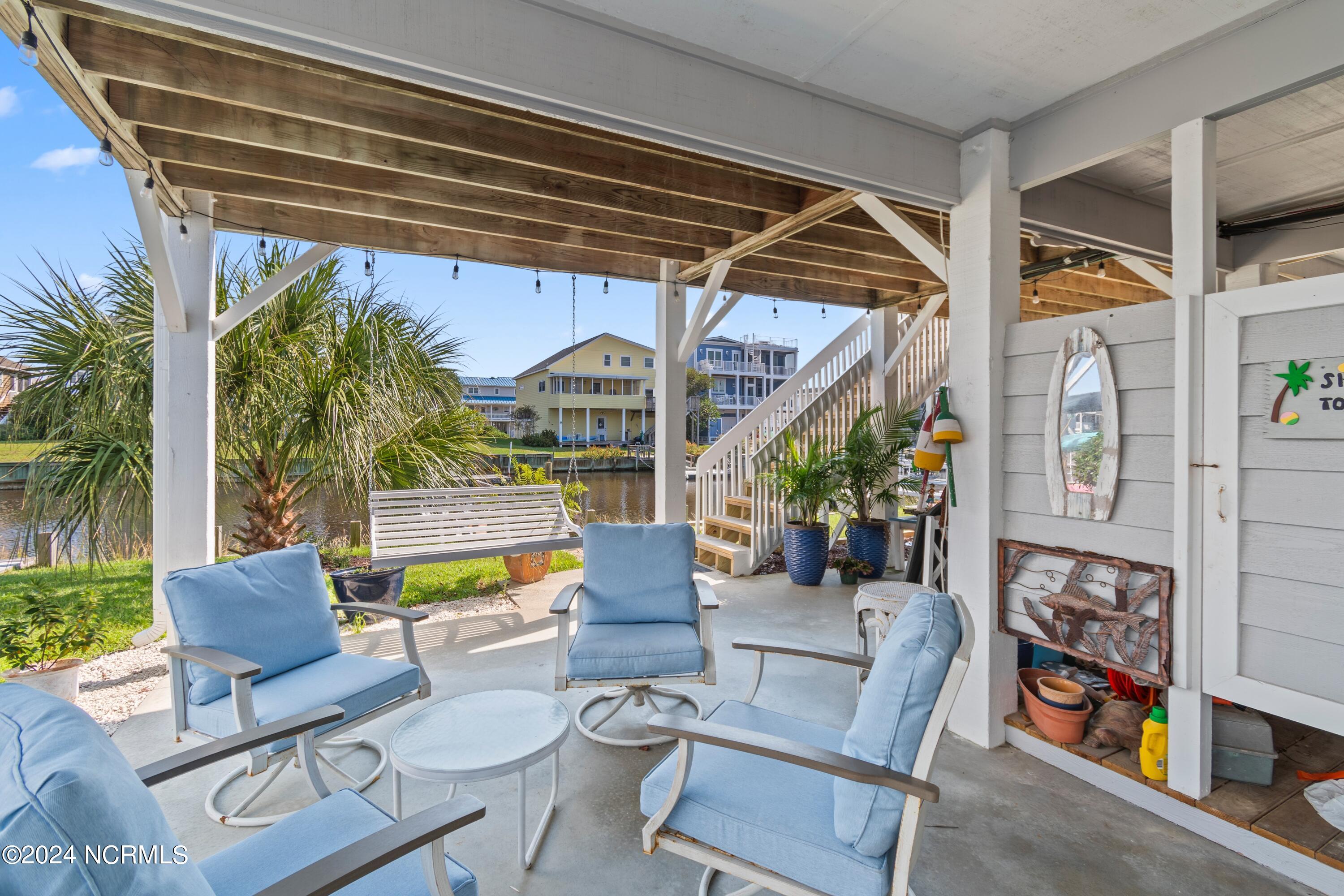 415 Sailfish Street Sunset Beach, NC 28468 - Photo 34 of 63 Under home seating. This home has tons of outdoor space for relaxing, storing beach essentials and parking.