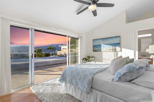 a living room with a bed and glass walk in closet