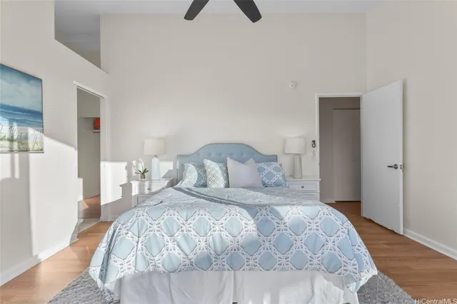 a bedroom with a bed and a painting on the wall