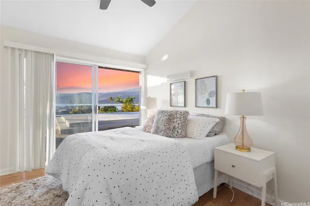 a bedroom with a large bed and a window