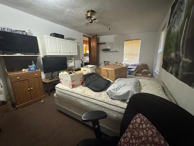 a bedroom with bed and window