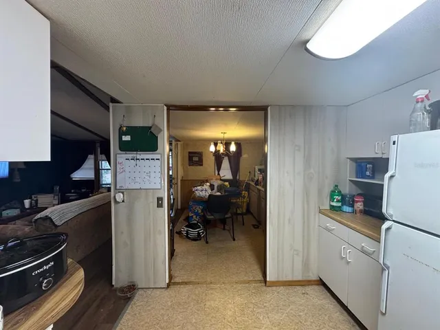 a kitchen with a refrigerator and furniture