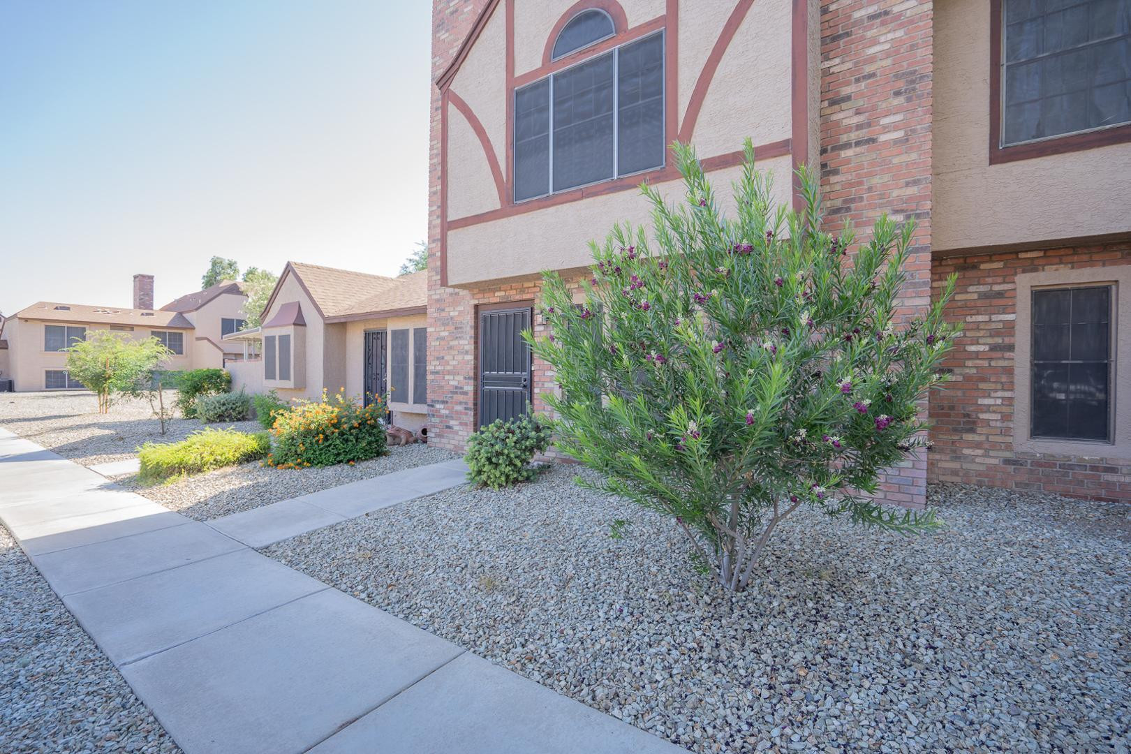 8111 West Wacker Road, Unit 70 Peoria, AZ 85381 - Photo 2 of 38 a view of a garden with a house