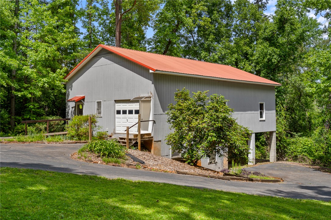 324 Hobson Road Anderson, SC 29621 - Photo 41 of 46 Workshop with passage and roll up door. In-Law or Guest studio suite on one side.