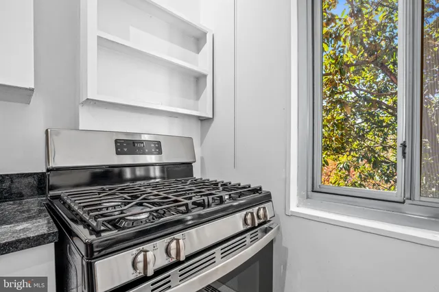 a stove top oven sitting inside of a kitchen