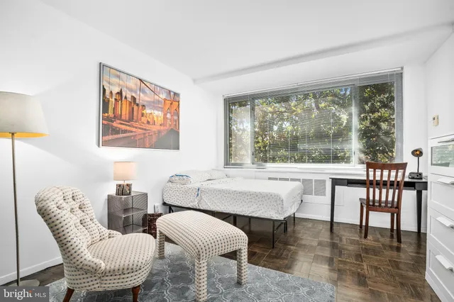 a dining room with furniture a large window and a rug