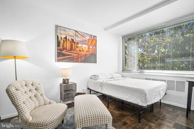 a living room with furniture a table and a large window