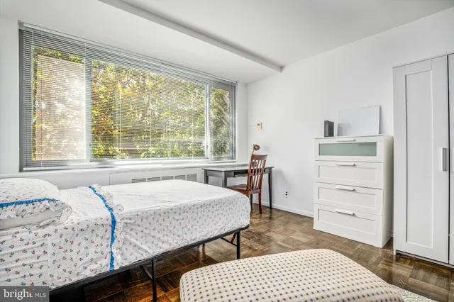 a bedroom with a bed and a window