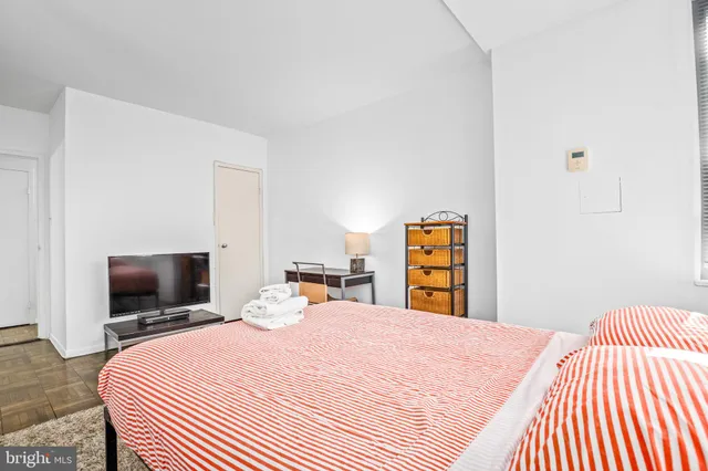 a bedroom with a bed and a tv