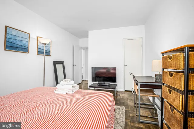 a bedroom with a bed and a flat screen tv