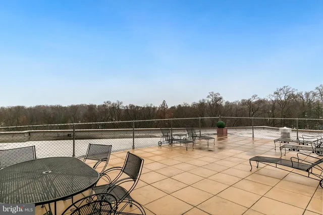 a terrace with outdoor seating and city view