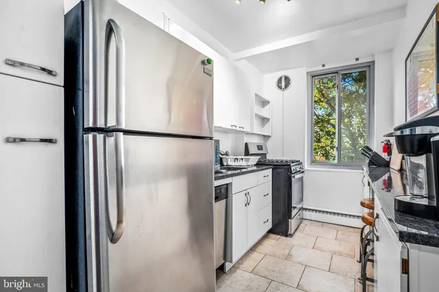 a kitchen with stainless steel appliances a refrigerator sink and microwave