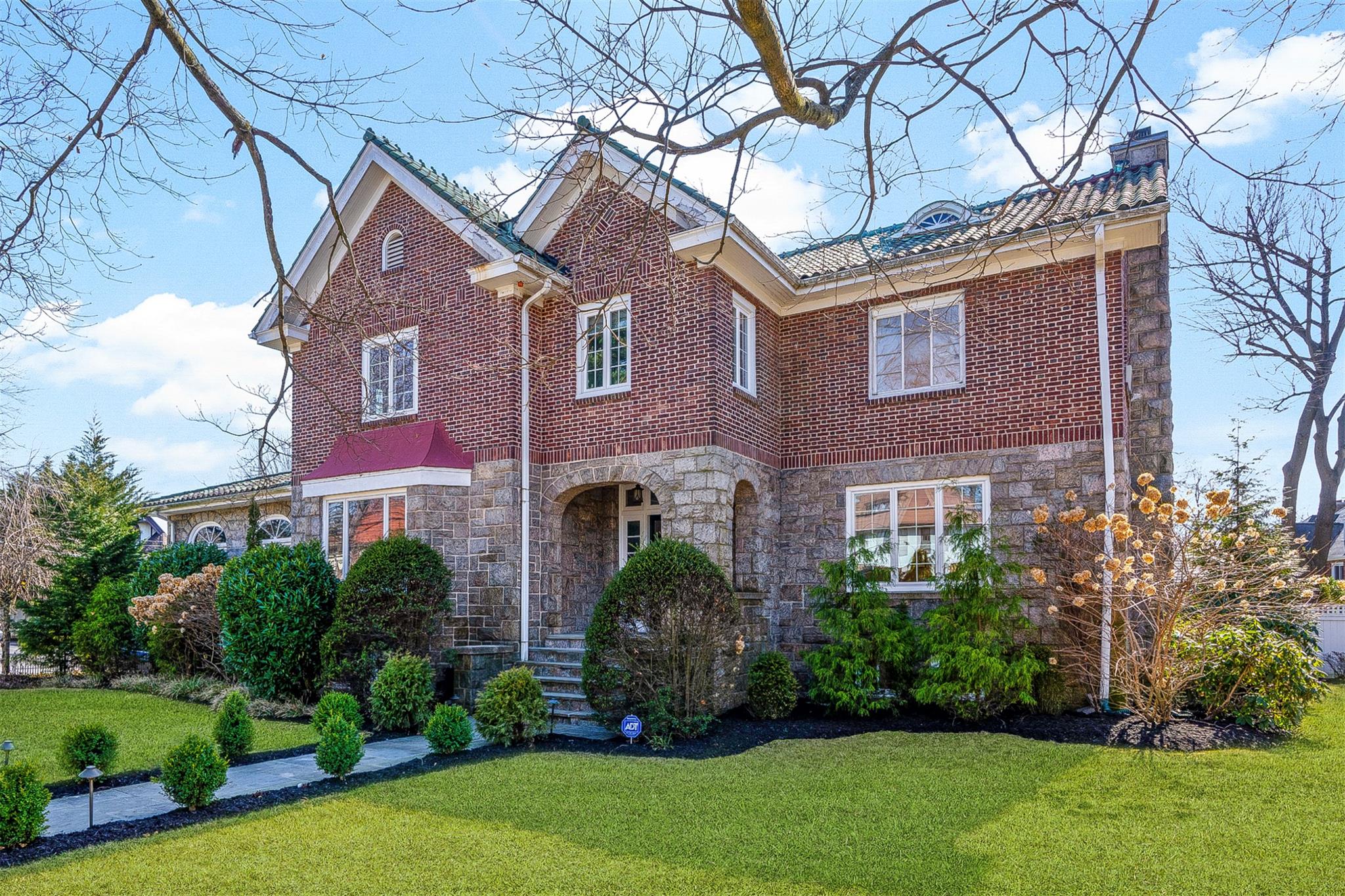 43 Cherry Avenue New Rochelle, NY 10801 - Photo 1 of 1 View of front of house with stone facade and front lawn