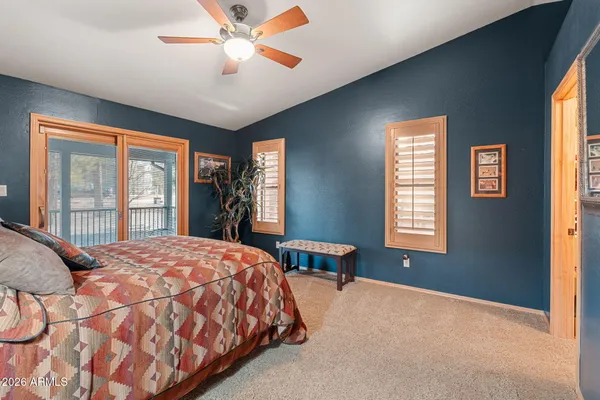 a view of balcony with chairs and wooden fence