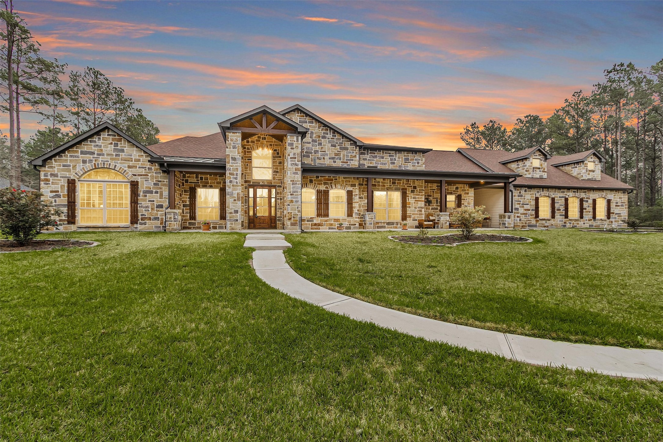 264 Grey Feather Road Huntsville, TX 77340 - Photo 1 of 31 a front view of a house with a garden