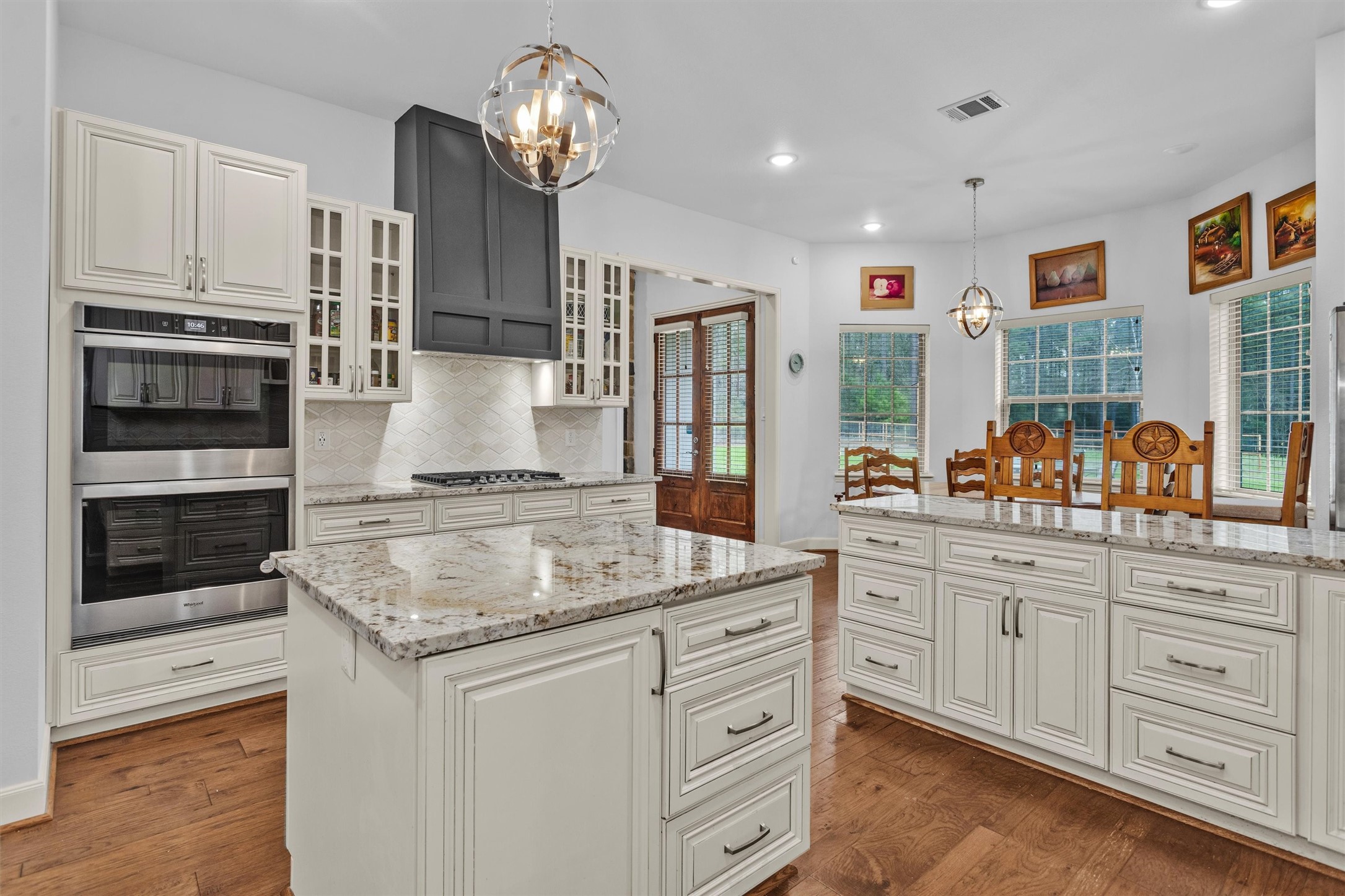 264 Grey Feather Road Huntsville, TX 77340 - Photo 11 of 31 a kitchen with stainless steel appliances granite countertop a stove oven and a refrigerator with white cabinets