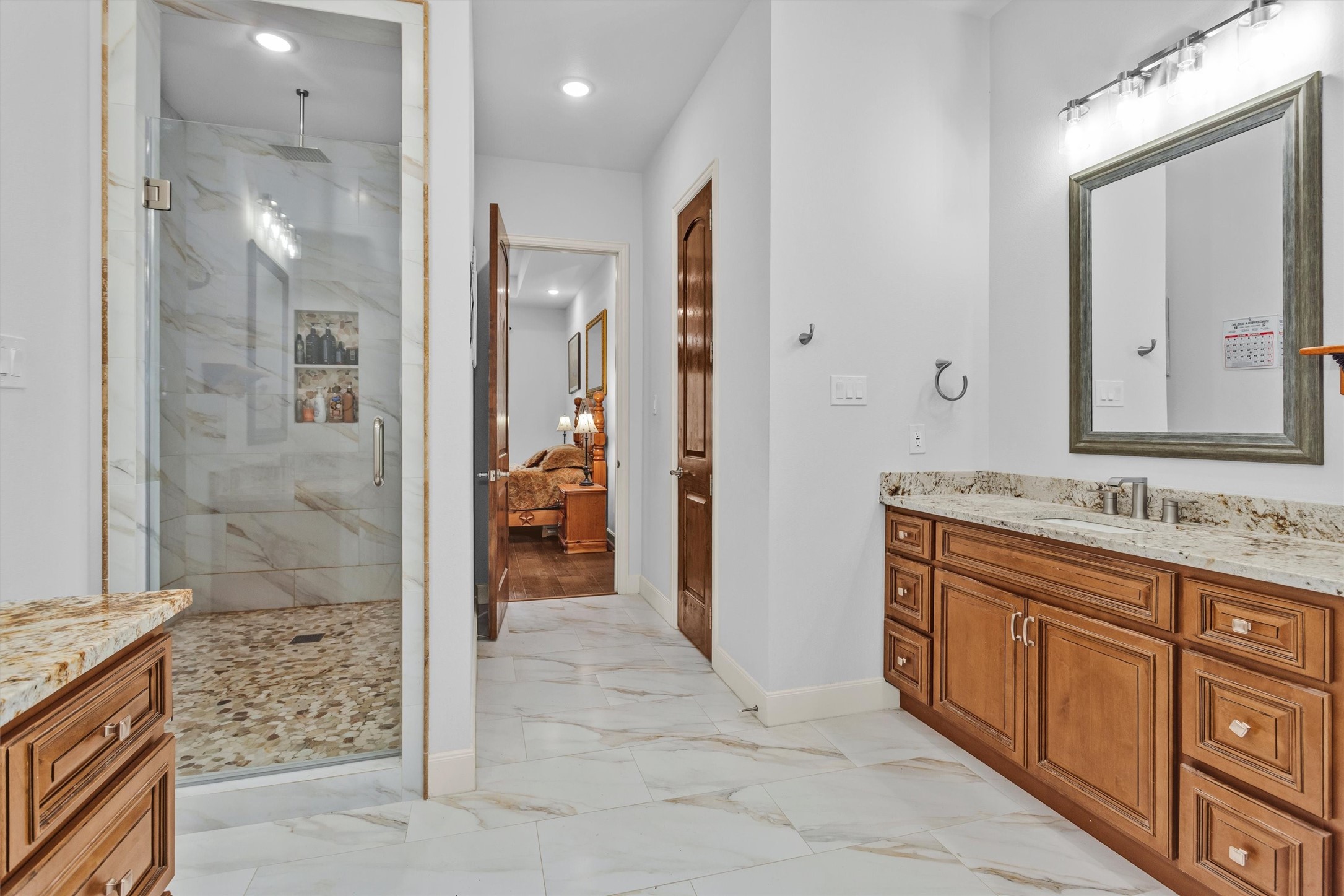 264 Grey Feather Road Huntsville, TX 77340 - Photo 17 of 31 a spacious bathroom with a granite countertop sink mirror and shower