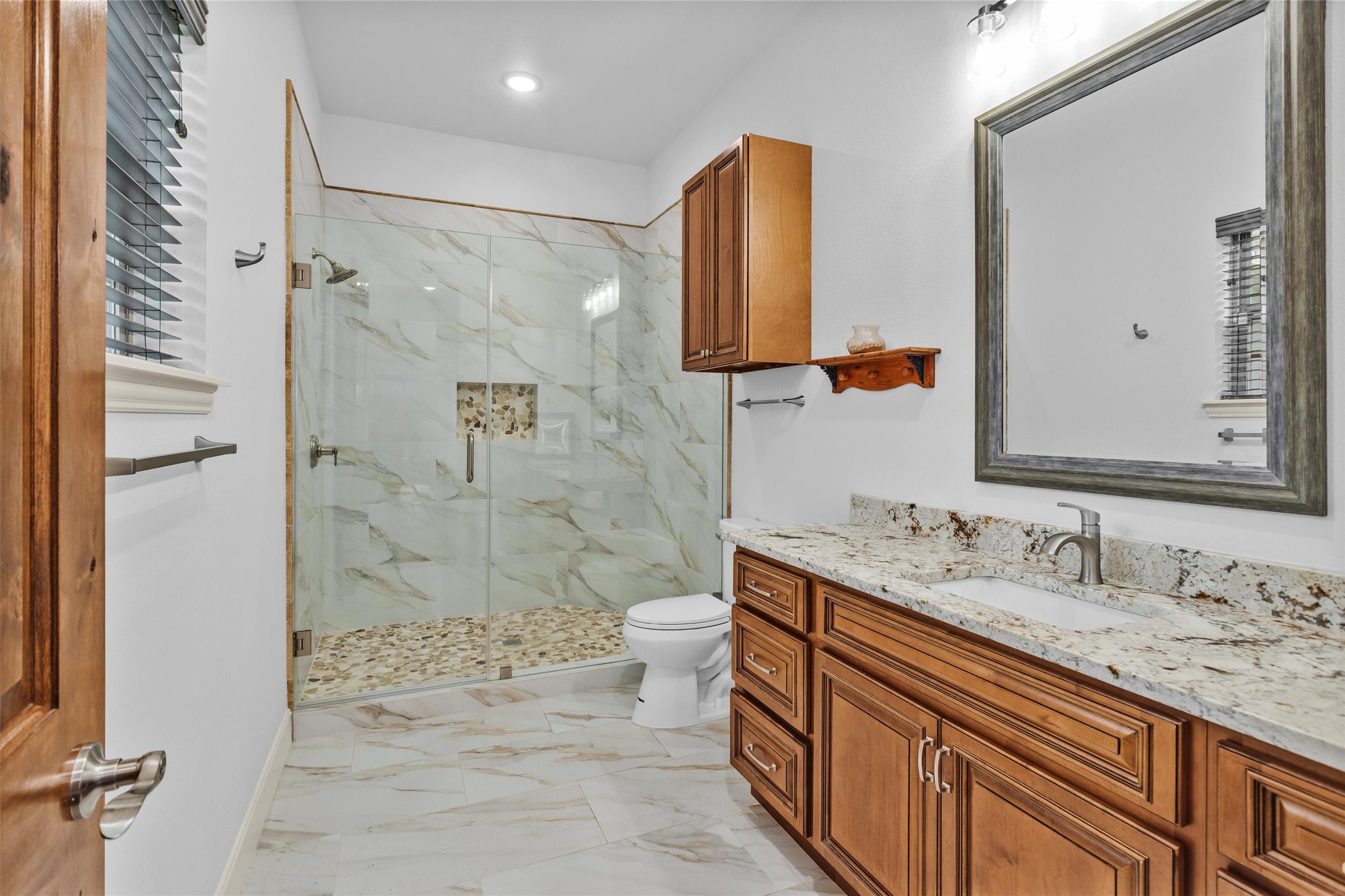 264 Grey Feather Road Huntsville, TX 77340 - Photo 20 of 31 a bathroom with a double vanity sink mirror and shower