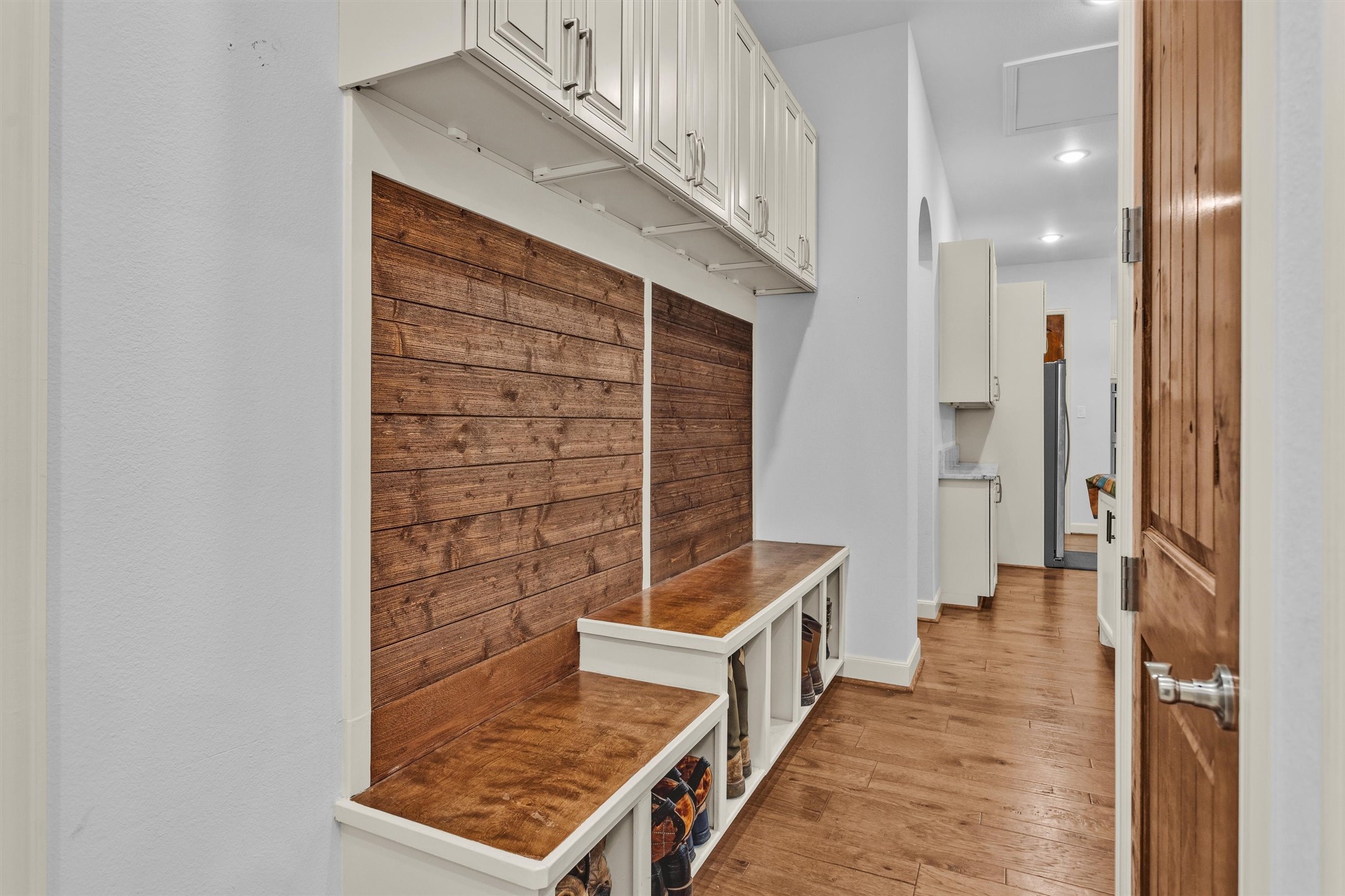 264 Grey Feather Road Huntsville, TX 77340 - Photo 21 of 31 a view of a hallway with wooden floor and staircase