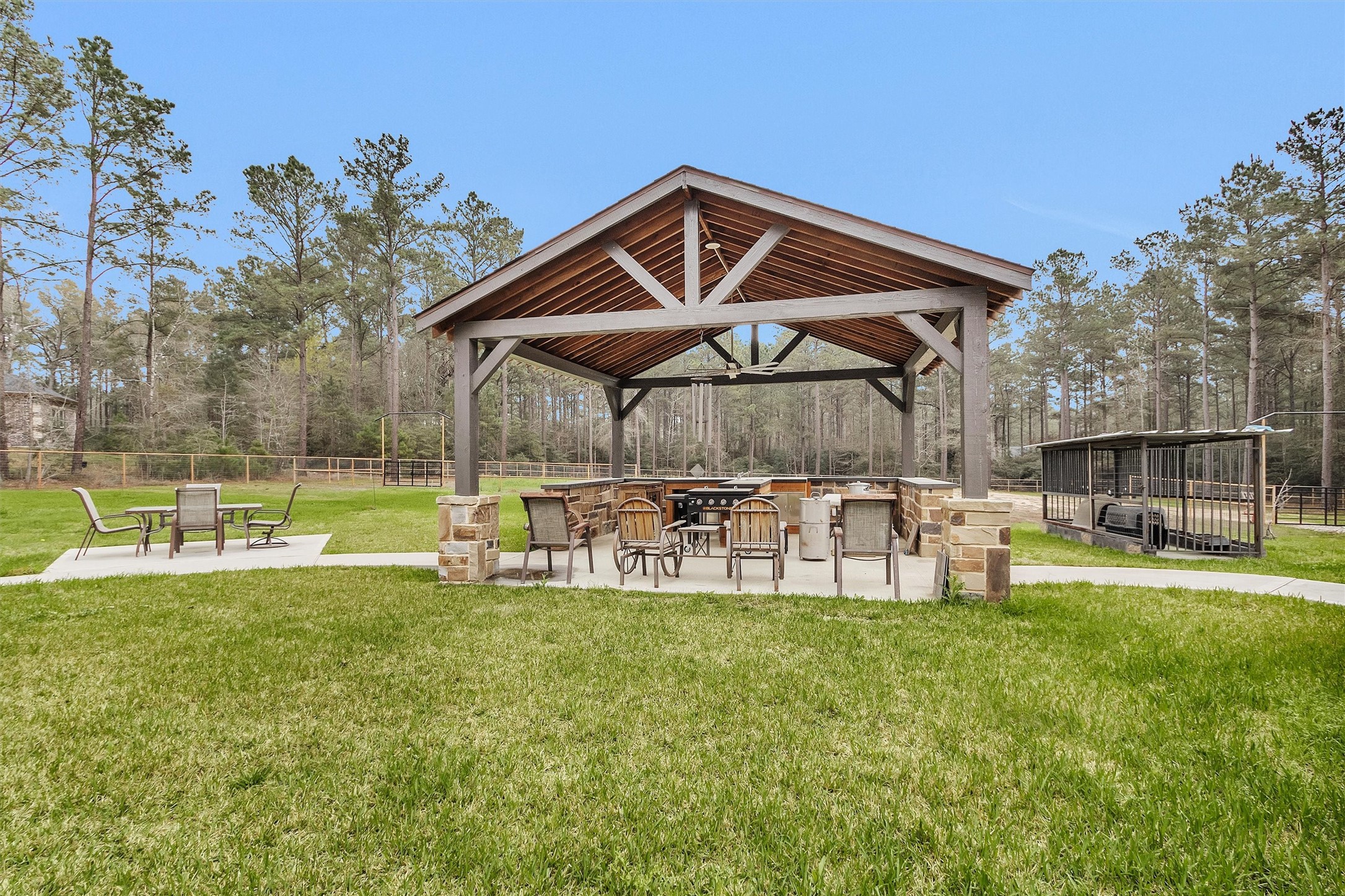 264 Grey Feather Road Huntsville, TX 77340 - Photo 4 of 31 a view of a chair and table of the garden