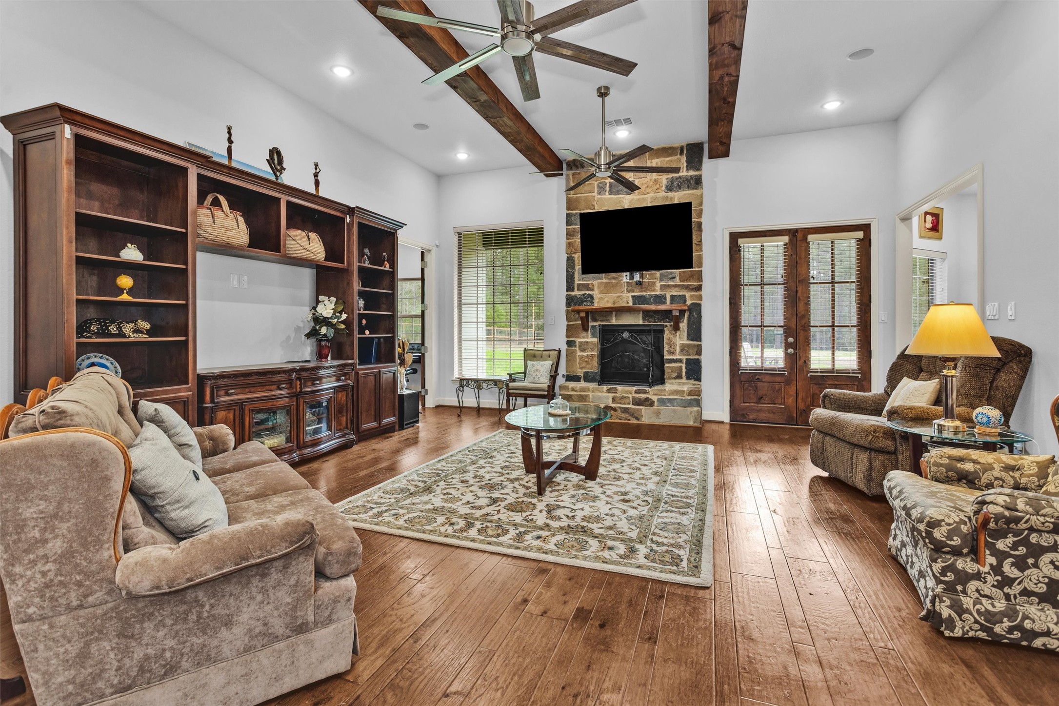 264 Grey Feather Road Huntsville, TX 77340 - Photo 8 of 31 a living room with fireplace furniture and a flat screen tv