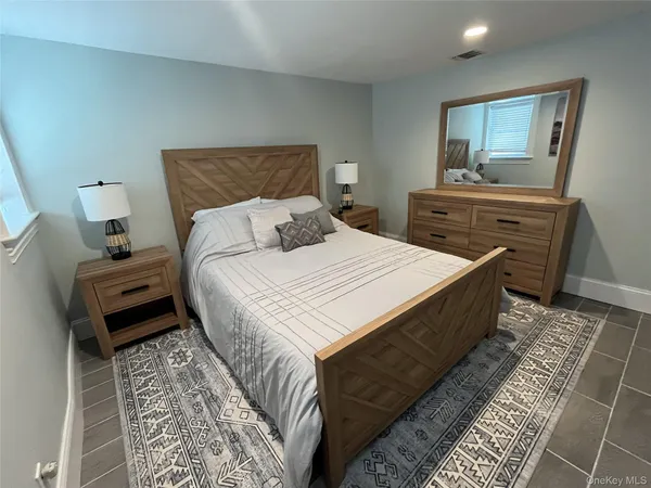 a bedroom with a bed and a dresser