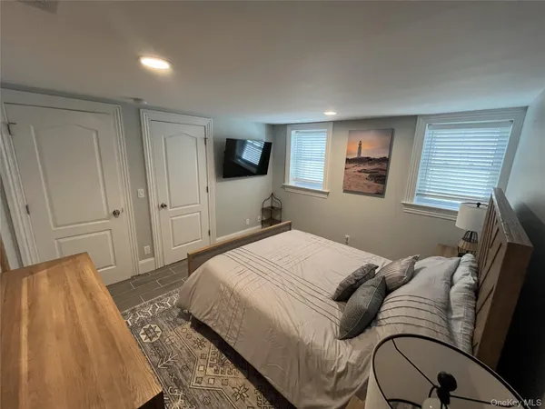 a bedroom with a large bed and a couch