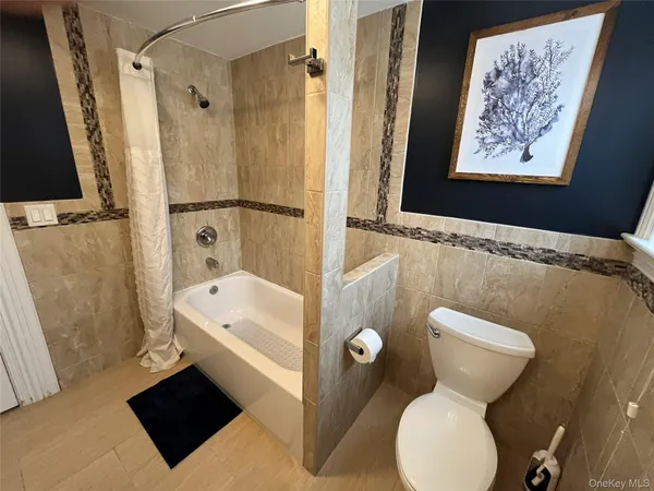 a bathroom with a sink mirror vanity and toilet