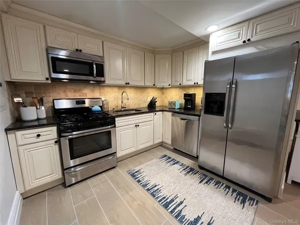 a kitchen with a refrigerator stove and microwave