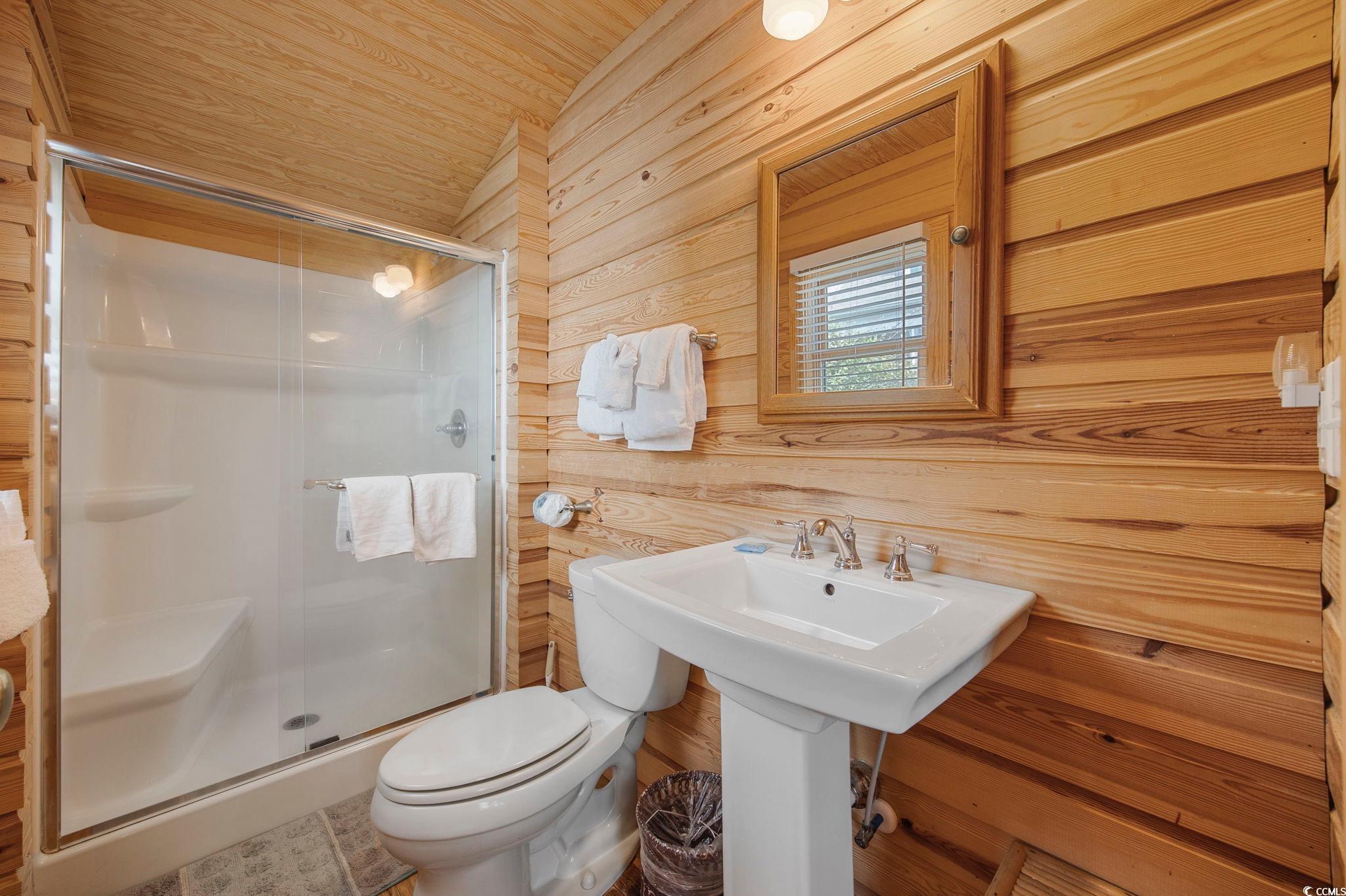 496 Myrtle Avenue Pawleys Island, SC 29585 - Photo 12 of 40 Bathroom with toilet, walk in shower, wooden walls, and wood ceiling
