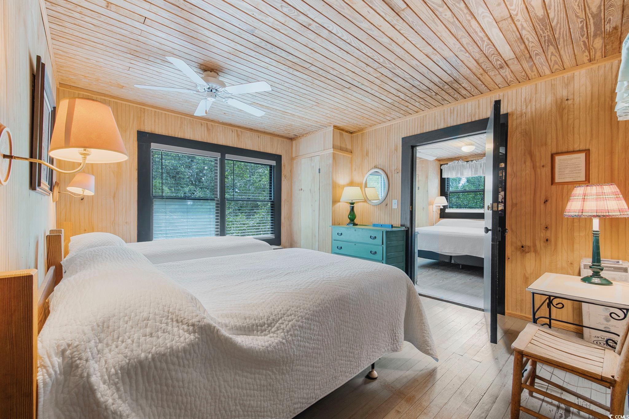 496 Myrtle Avenue Pawleys Island, SC 29585 - Photo 32 of 40 Bedroom featuring wooden ceiling, wooden walls, and wood-type flooring