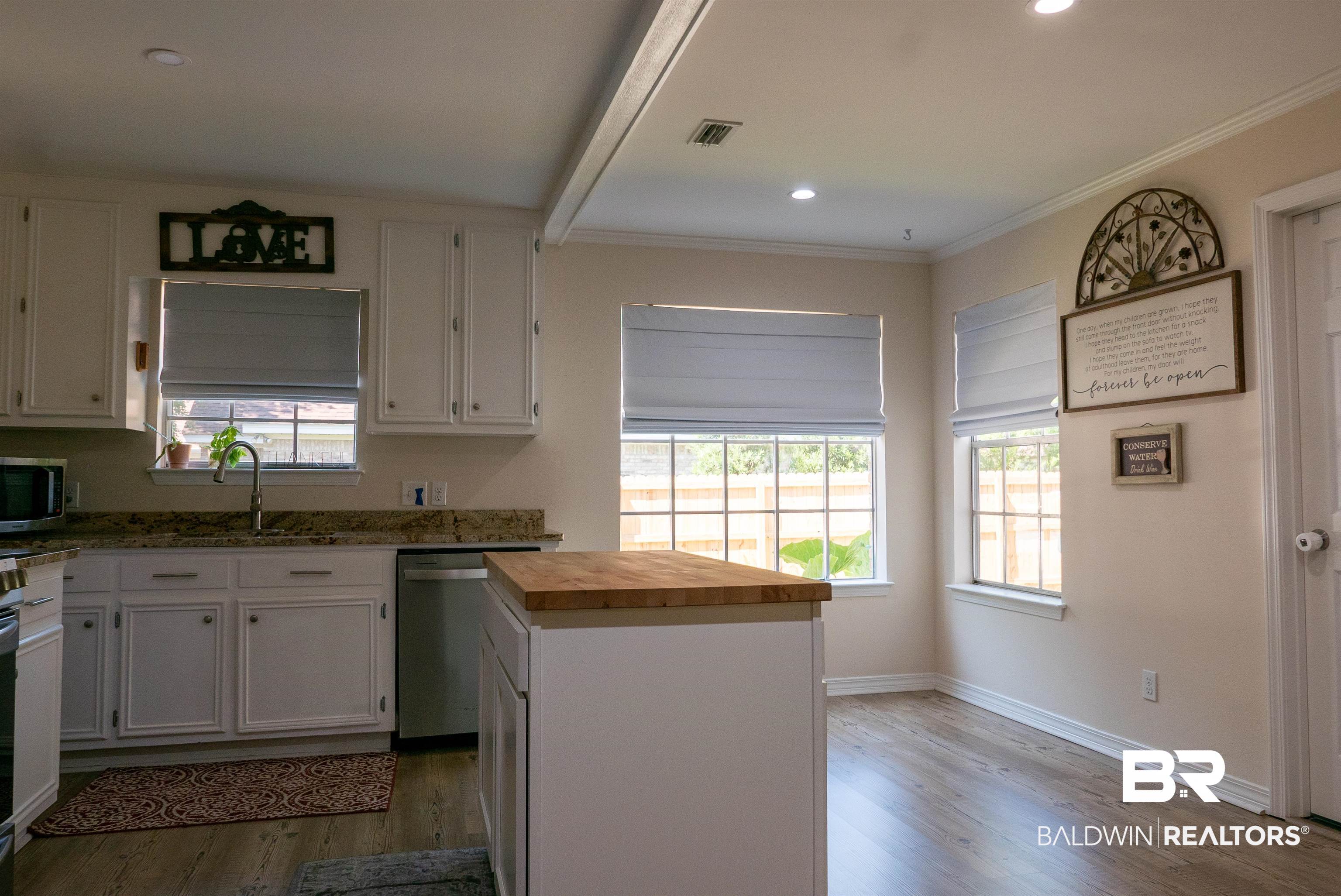 630 Spanish Main Daphne, AL 36527 - Photo 4 of 40 Kitchen featuring light hardwood / wood-style flooring, stainless steel appliances, butcher block countertops, and white cabinetry