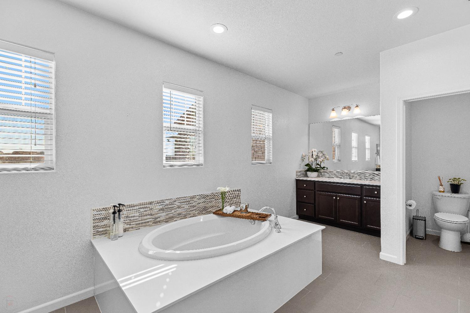 2305 Augusta Avenue Tracy, CA 95377 - Photo 44 of 91 a bathroom with a sink double vanity granite tub and a mirror