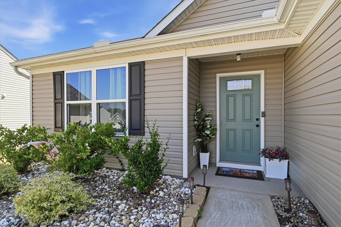117 Alice Court Easley, SC 29642 - Photo 2 of 26 A welcoming entry invites with a cool-toned door and neat landscaping.
