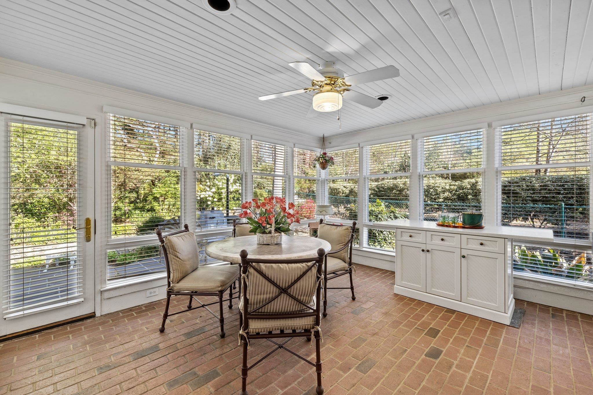3608 Dover Road Durham, NC 27707 - Photo 20 of 60 a view of a dining room with furniture a chandelier and wooden floor