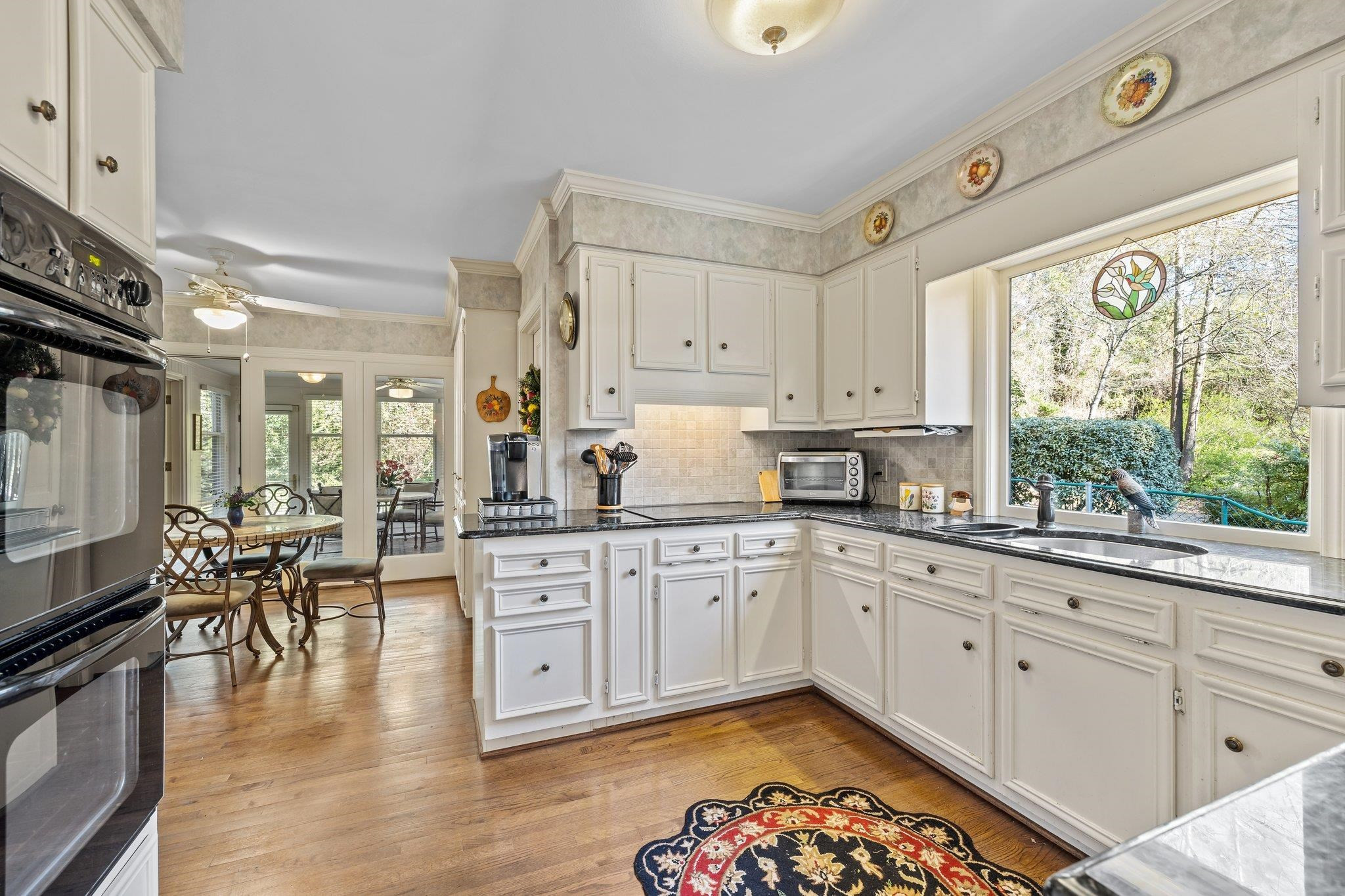 3608 Dover Road Durham, NC 27707 - Photo 24 of 60 a kitchen with stainless steel appliances granite countertop a stove and white cabinets