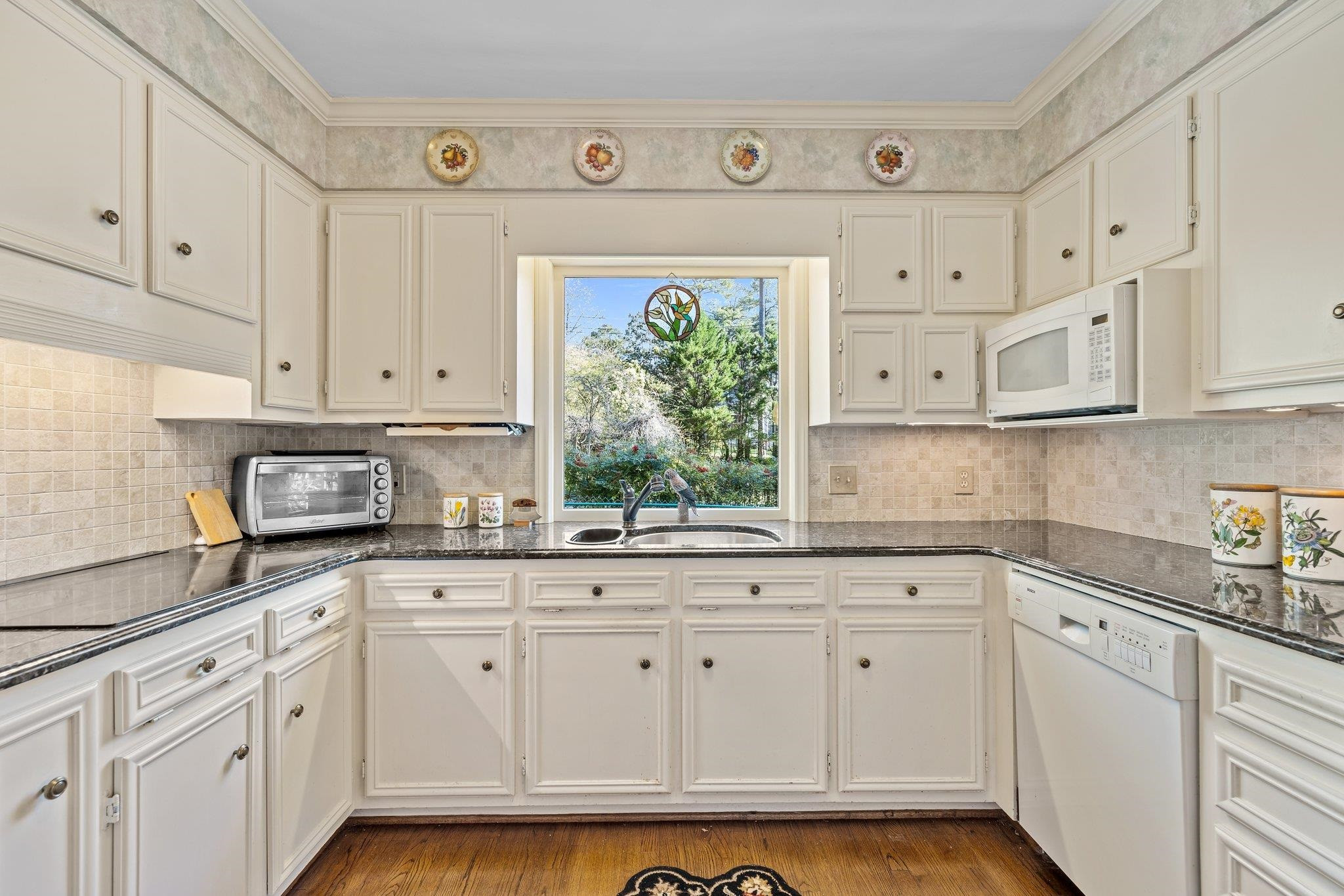 3608 Dover Road Durham, NC 27707 - Photo 25 of 60 a kitchen with granite countertop white cabinets and white appliances