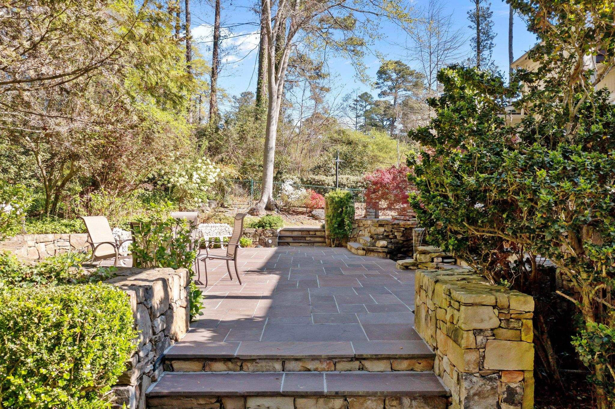 3608 Dover Road Durham, NC 27707 - Photo 32 of 60 a wooden bench sitting in front of a building