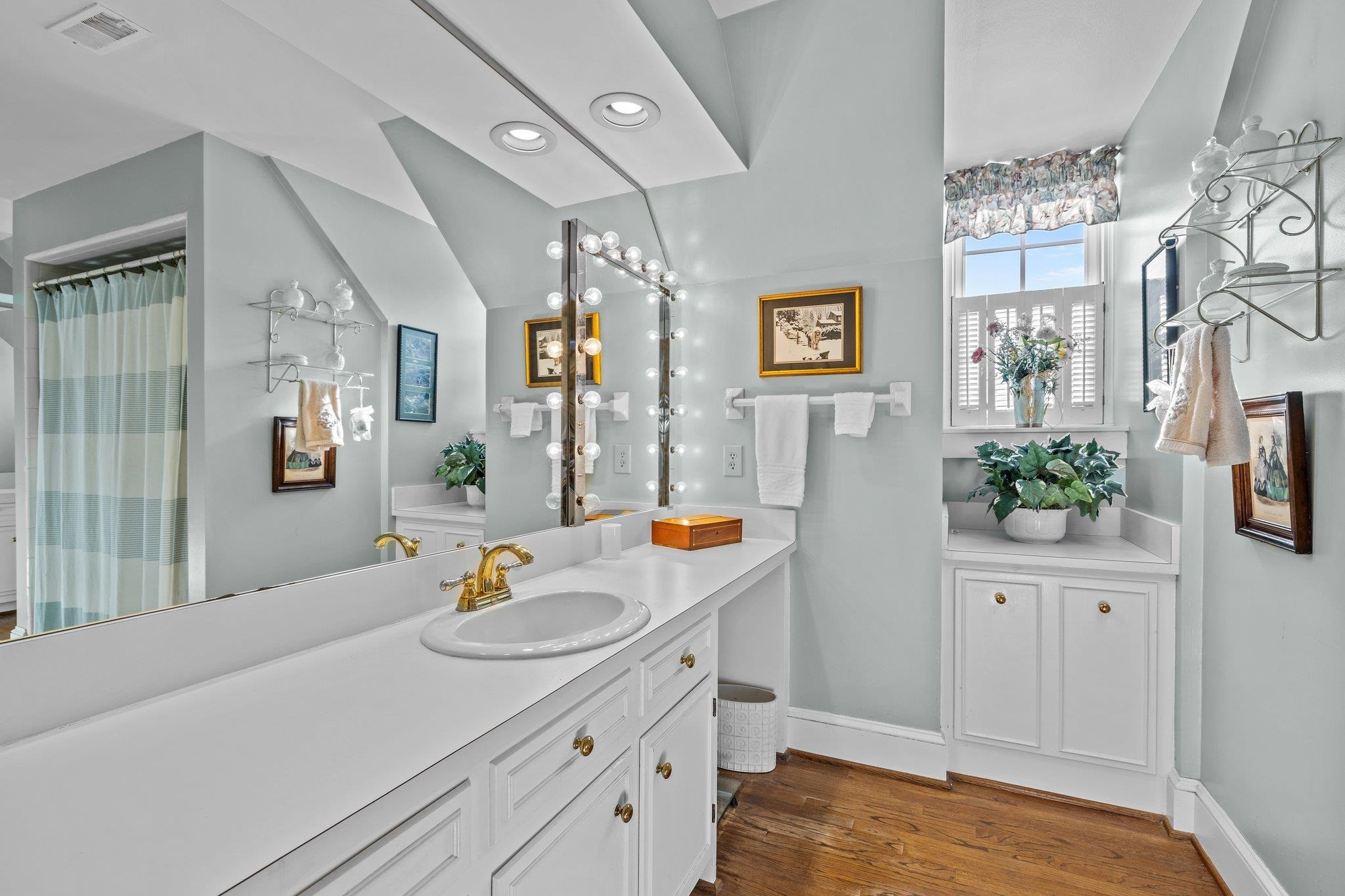 3608 Dover Road Durham, NC 27707 - Photo 42 of 60 a bathroom with a sink a faucet a mirror and a shower